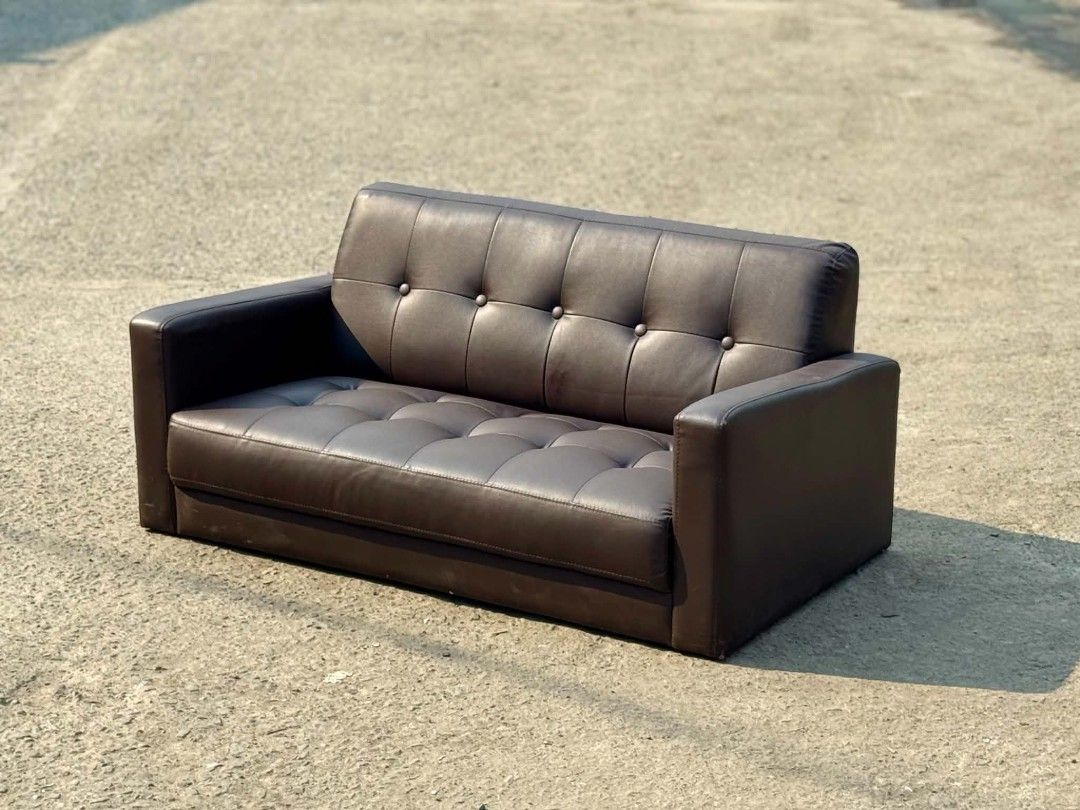 Brown Tufted Faux Leather 2-Seater Sofa (Category: Sofas) located in Valenzuela. Submitted by upcycle_things (Listing ID 1445688980, Image 2). Description: - Brown faux leather sofa - Tufted backrest and seat cushions - Comfortably seats two people - Ideal for small living rooms or apartments - Ready for a new home.
