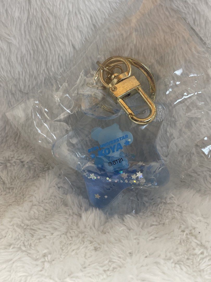 BT21 KOYA Acrylic Glitter Keyholder Keychain (Category: Character Goods) located in Quezon City. Submitted by end_less_repeat (Listing ID 1445756625, Image 2). Description: - Adorable blue KOYA keychain - Star-shaped design with glitter - Includes a gold keyring and clasp - Official BT21 merchandise - Ideal for decorating bags or keys.