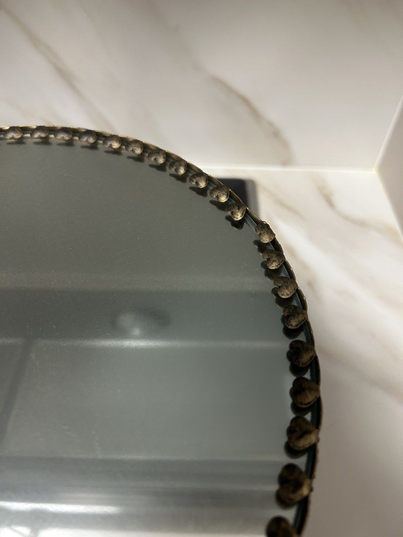 Cake Stand (Category: Bakeware) located in Singapore. Submitted by the.petite.wardrobe (Listing ID 1445760721, Image 3). Description: - Ornate gold-trimmed cake stand - Mirrored top surface - Vintage distressed gold base finish - Ideal for displaying cakes, desserts, or as a decorative centerpiece - Beautiful light reflection from mirrored surface - Dimensions: diameter (25.5cm), height (13.5cm), base stand diameter (12.5cm) - Suitable for partie