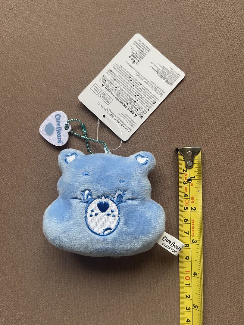 Care Bears Blue Bear Plush Keychain with Tag (Category: Plushies & Soft Toys) located in Manila. Submitted by shopandscore (Listing ID 1445688230, Image 2). Description: - Adorable blue Care Bear plush keychain - Original tag still attached - Small size, ideal for decorating bags or keys - Made with soft, huggable material - Part of the beloved Care Bears collection - Manufactured in China.