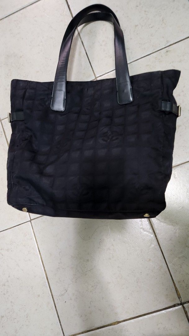 Chanel Black Nylon Tote Bag (Category: Luxury Bags & Wallets) located in Quezon City. Submitted by ctatel (Listing ID 1445684962, Image 1). Description: - Authentic Black Chanel Tote Bag - Durable Nylon Material with Signature CC Logo Pattern - Holo intact with authencity card - Genuine Leather Handles - Secure Zipper Closure - Interior Zip Pocket for Organization - Shows some signs of wear (exterior & interior) - Perfect for everyday use.