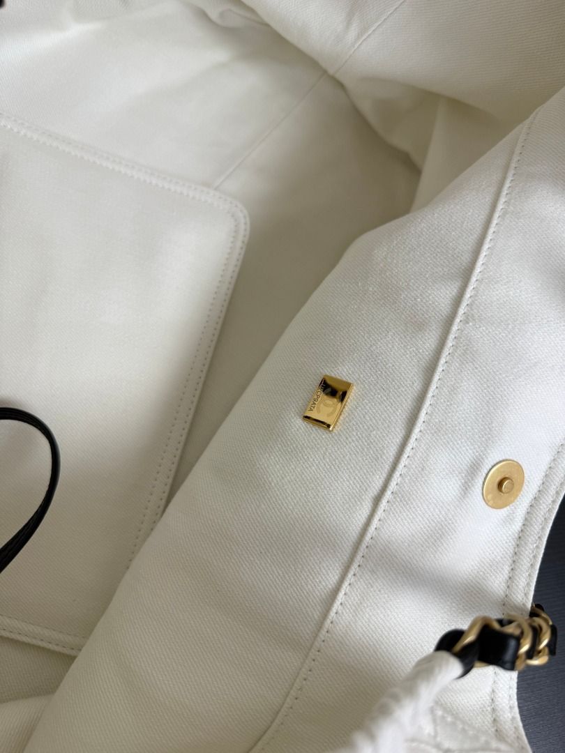 Chanel White Canvas CC Logo Chain Shoulder Bag (Category: Luxury Bags & Wallets) located in Paranaque City. Submitted by daneauassc54982 (Listing ID 1445660693, Image 2). Description: - Authentic Chanel shoulder bag - Color: White canvas - Iconic black CC logo on front - Gold and black chain strap - Elegant quilted pattern - Versatile for everyday or special events - A timeless fashion statement.