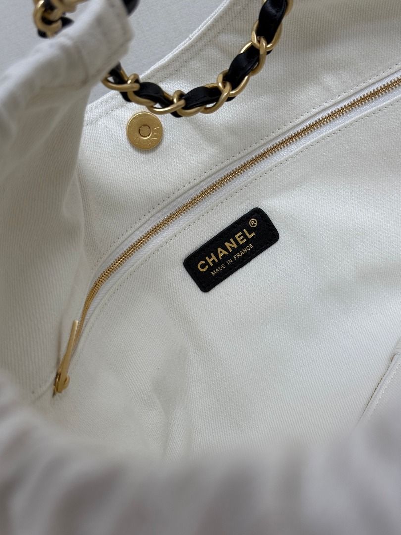 Chanel White Canvas CC Logo Chain Shoulder Bag (Category: Luxury Bags & Wallets) located in Paranaque City. Submitted by daneauassc54982 (Listing ID 1445660693, Image 3). Description: - Authentic Chanel shoulder bag - Color: White canvas - Iconic black CC logo on front - Gold and black chain strap - Elegant quilted pattern - Versatile for everyday or special events - A timeless fashion statement.