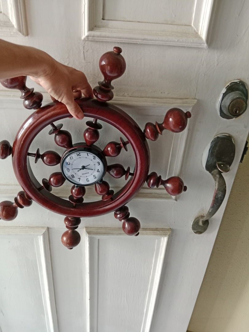 Clock (Category: Wall Decor) located in Singapore. Submitted by janetsklim (Listing ID 1445672369, Image 3). Description: - Unique ship's wheel design clock - Adds a nautical or vintage touch to any room - Made of wood with a rich finish - Eye-catching and decorative piece.