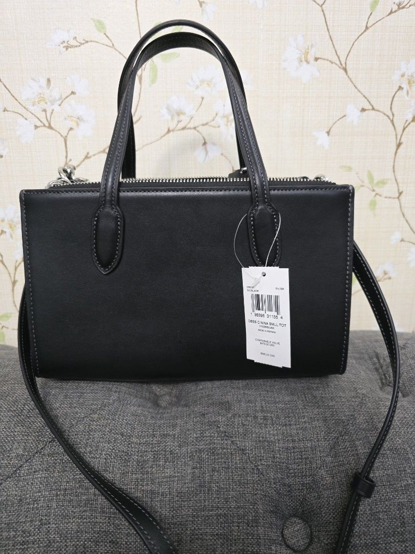 Coach Nina Mini (Category: Luxury Bags & Wallets) located in Quezon City. Submitted by iammjdlb (Listing ID 1445747440, Image 2). Description: - Authentic Coach black leather tote bag - Top handles and detachable shoulder strap - Signature horseshoe detail on the front - Multiple interior pockets for organization - Comes with original tags and silica gel packets.