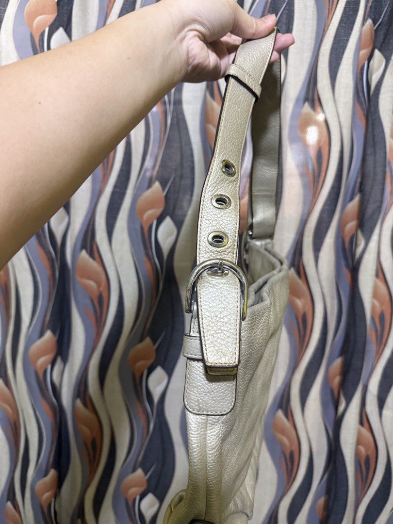 Coach Leather Hobo Shoulder Bag - Silver (Category: Shoulder Bags) located in Tanauan. Submitted by swifttiger.c7f149 (Listing ID 1445675935, Image 2). Description: - Brand: Coach - Style: Hobo Bag - Material: Soft, textured leather - Color: Silver (versatile) - Exterior: Zip pocket on the back - Interior: Lined - Strap: Adjustable with buckle - Ideal for: Everyday use.