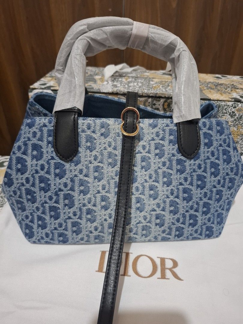 Dior Denim Monogram Tote Bag with Pouch (Category: Luxury Bags & Wallets) located in Manila. Submitted by brekkas.ph (Listing ID 1441228931, Image 1). Description: - Authentic Dior tote bag - Classic blue denim with signature monogram print - Includes a matching zippered pouch - Durable black leather handles and trim - Elegant gold-tone 'Dior' charms - Ideal for everyday style and practicality P12800.