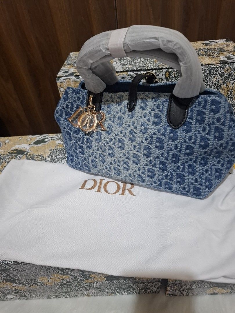 Dior Denim Monogram Tote Bag with Pouch (Category: Luxury Bags & Wallets) located in Manila. Submitted by brekkas.ph (Listing ID 1441228931, Image 2). Description: - Authentic Dior tote bag - Classic blue denim with signature monogram print - Includes a matching zippered pouch - Durable black leather handles and trim - Elegant gold-tone 'Dior' charms - Ideal for everyday style and practicality P12800.