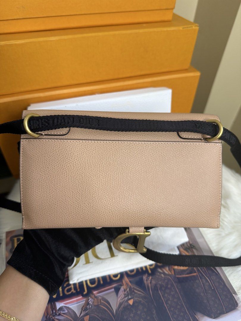 Dior Saddle Clutch Beige Leather (Category: Luxury Bags & Wallets) located in Caloocan City. Submitted by marj_bags (Listing ID 1445646416, Image 2). Description: - Authentic Dior Saddle wallet clutch - Color: Beige - Material: Textured leather - Hardware: Gold 'D' charm - Strap: Black with Dior branding - Style: Compact and stylish - Function: Ideal for essentials -Comes with dustbag and box.