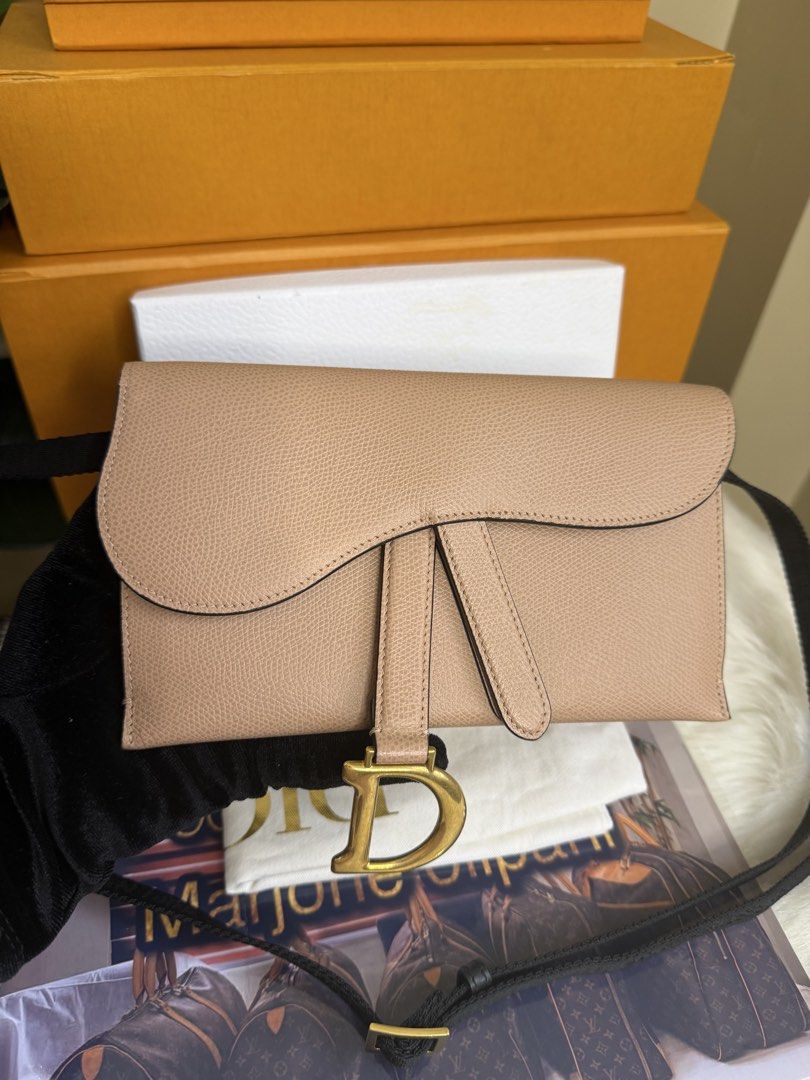 Dior Saddle Clutch Beige Leather (Category: Luxury Bags & Wallets) located in Caloocan City. Submitted by marj_bags (Listing ID 1445646416, Image 1). Description: - Authentic Dior Saddle wallet clutch - Color: Beige - Material: Textured leather - Hardware: Gold 'D' charm - Strap: Black with Dior branding - Style: Compact and stylish - Function: Ideal for essentials -Comes with dustbag and box.