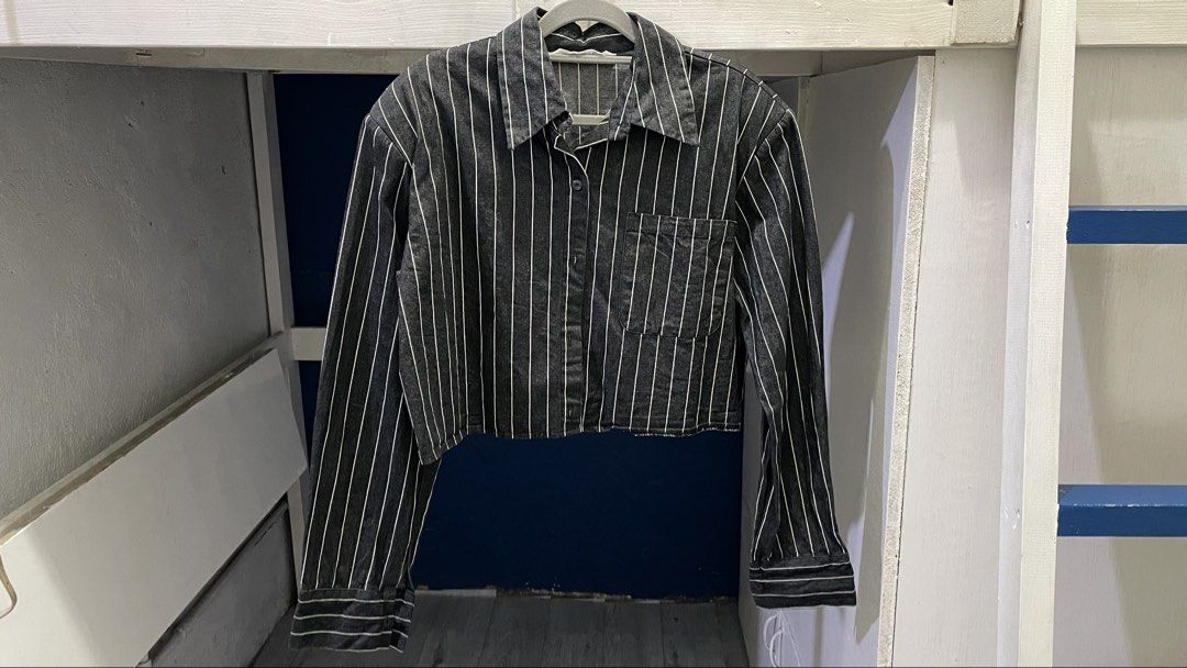 DIRECTOR Striped Cropped Polo Longsleeve (Category: Shirts) located in Manila. Submitted by madj17_ (Listing ID 1445768466, Image 1). Description: - Brand: DIRECTOR - Style: Striped cropped shirt - Closure: Button-up front - Details: Chest pocket, long sleeves with button cuffs, raw hem, thick fabric - Features: Built-in shoulder pads - Versatile: Great for layering or wearing solo Color: Dark Gray Size: Medium-Large Condition: Good as new. Used 