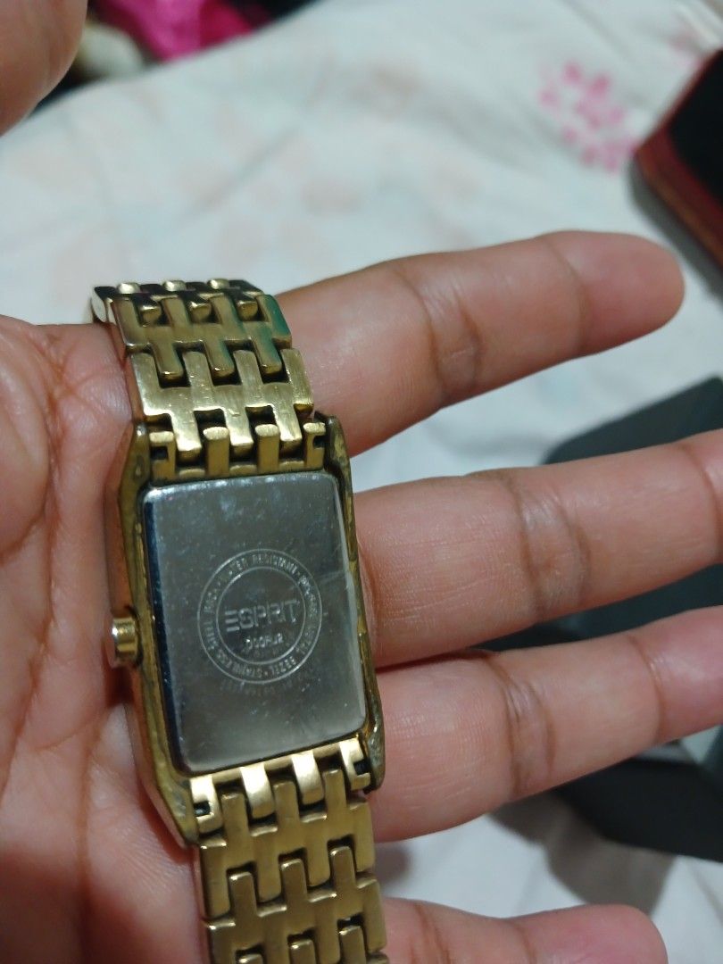 Esprit Gold Tone Watch with Rhinestones (Category: Women's Watches) located in Marikina City. Submitted by laila15 (Listing ID 1445777511, Image 2). Description: - Elegant gold tone watch - Rectangular face with Roman numeral dial - Bezel adorned with sparkling rhinestones - Classic link watch band - Includes original box - Versatile for everyday or special occasions -Available .