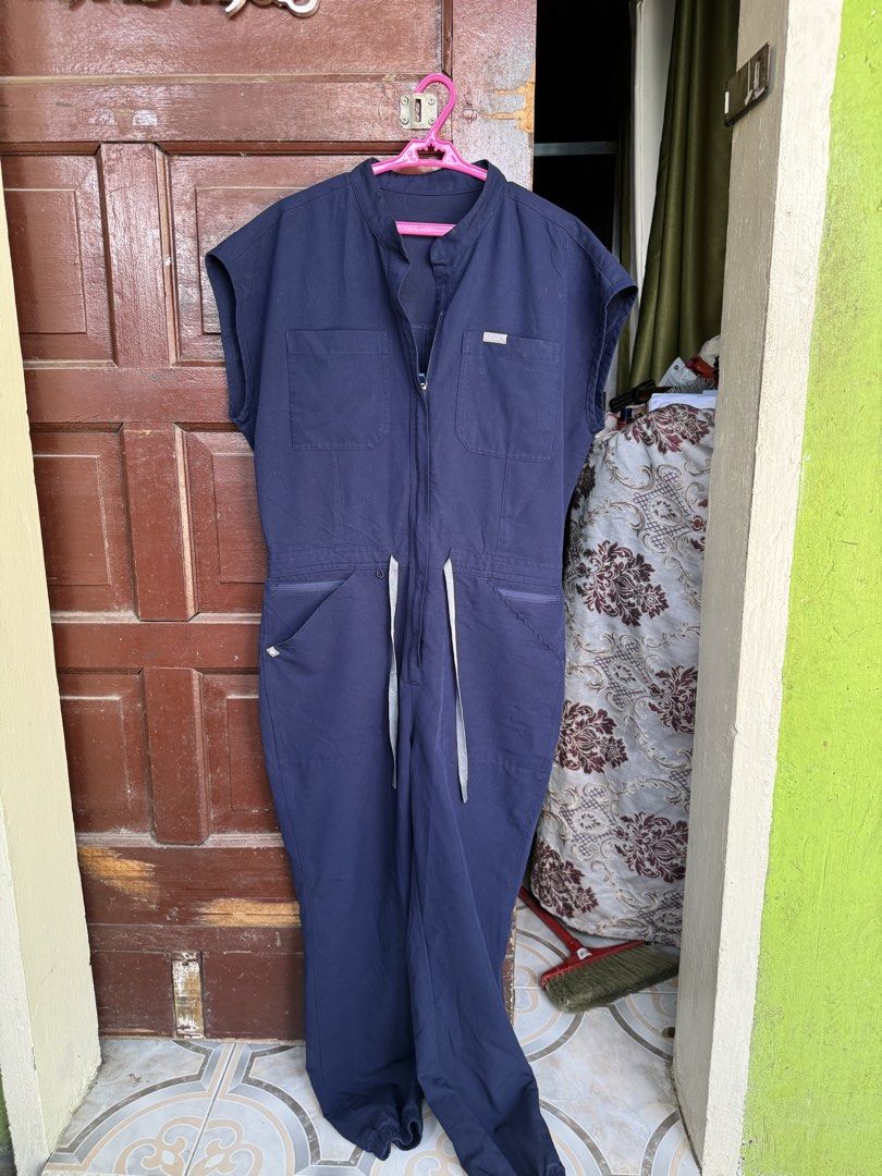 FIGS Rafaela Cargo Scrub Jumpsuit Navy Blue (Category: Jumpsuits) located in Imus. Submitted by mevangkiangco (Listing ID 1445698742, Image 2). Description: - Navy blue FIGS Rafaela Cargo Scrub Jumpsuit - Features multiple pockets - Adjustable drawstring waist for a comfortable fit - Made in Vietnam - Material: 72% Polyester, 21% Rayon, 7% Spandex - SIZE MEDIUM LOCATION: IMUS CAVITEO.