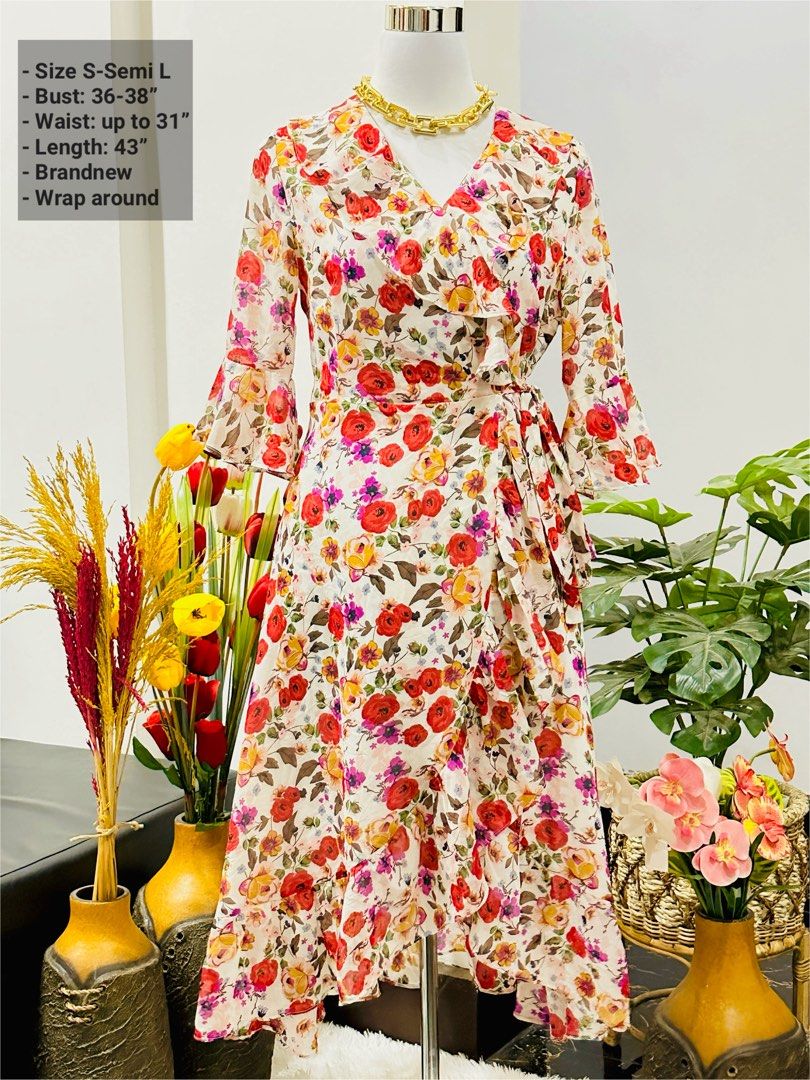 Floral Wrap Around Dress (Category: Dresses) located in Bugallon. Submitted by itskierbrielle (Listing ID 1445761751, Image 1). Description: - White wrap dress with a vibrant floral print - Ruffled details along the neckline and hem - Stylish bell sleeves - Length: 43 inches - Fits bust: 36-38 inches - Fits waist: up to 31 inches - Versatile for any occasion.