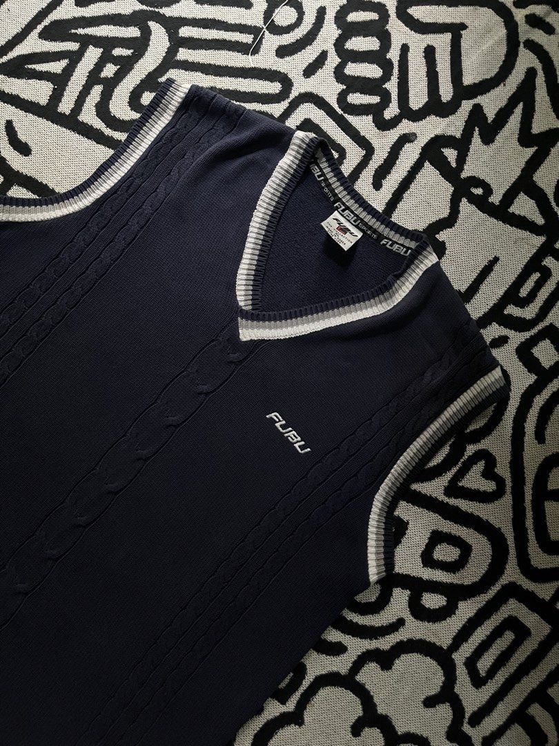 FUBU Navy Blue V-Neck Cable Knit Vest (Category: Vests) located in Silang. Submitted by yusthrift (Listing ID 1445681740, Image 2). Description: - Classic FUBU vest - Navy blue with white and grey trim - Cable knit detailing on the front - Ideal for layering over shirts - Sharp and stylish streetwear piece Size: XL 22.5 inc width 30 inc length No issue Very good condition .