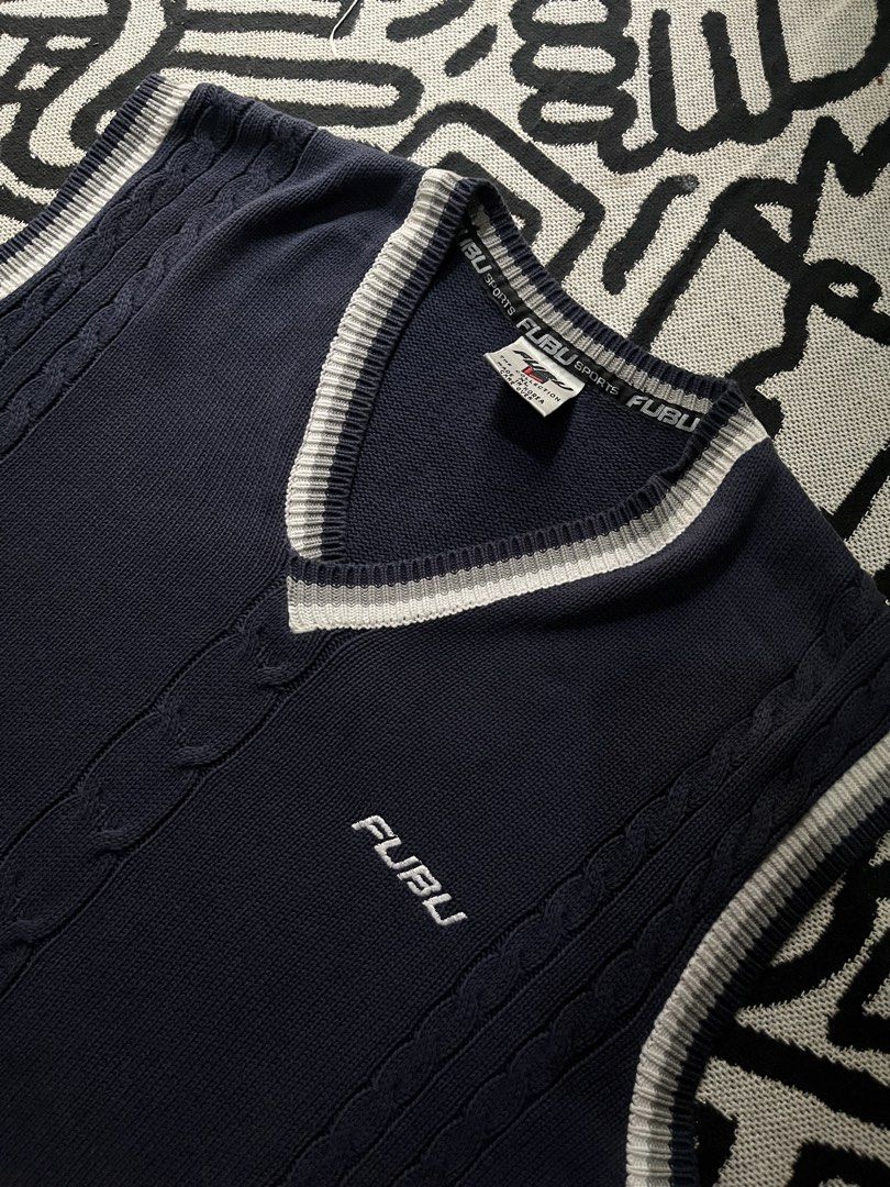 FUBU Navy Blue V-Neck Cable Knit Vest (Category: Vests) located in Silang. Submitted by yusthrift (Listing ID 1445681740, Image 3). Description: - Classic FUBU vest - Navy blue with white and grey trim - Cable knit detailing on the front - Ideal for layering over shirts - Sharp and stylish streetwear piece Size: XL 22.5 inc width 30 inc length No issue Very good condition .