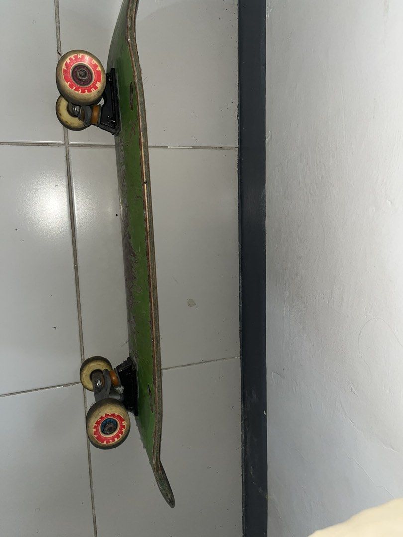 Green Skateboard with White Lightning Bolt Graphic (Category: Skates, Rollerblades & Scooters) located in Manila. Submitted by epiccloud_1897cb (Listing ID 1445736080, Image 1). Description: - Green skateboard deck with a cool white lightning bolt graphic. - Features 'TUBERO' branded trucks. - Deck has scuffs and scratches from previous skating sessions. - Still ready for your next skate adventure!.