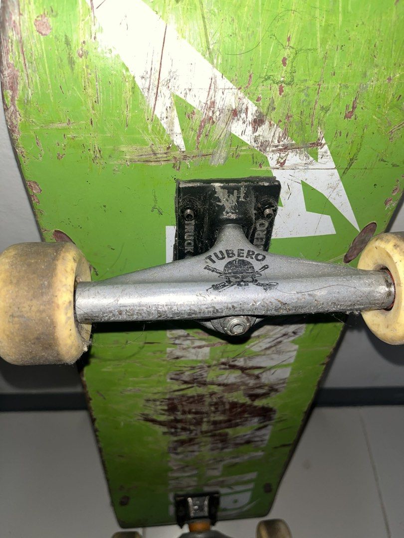 Green Skateboard with White Lightning Bolt Graphic (Category: Skates, Rollerblades & Scooters) located in Manila. Submitted by epiccloud_1897cb (Listing ID 1445736080, Image 2). Description: - Green skateboard deck with a cool white lightning bolt graphic. - Features 'TUBERO' branded trucks. - Deck has scuffs and scratches from previous skating sessions. - Still ready for your next skate adventure!.