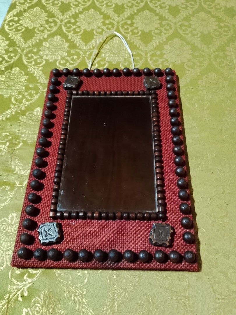Handmade Decorative Mirror with Red Burlap and Beads (Category: Mirrors) located in Manila. Submitted by youngdragon.0d29ca (Listing ID 1445750957, Image 2). Description: - Unique wall mirror - Red burlap frame - Decorated with dark beads and small square embellishments - Rustic, handmade aesthetic - Perfect decorative accent for any room - Comes with a string for hanging - Wood backing.