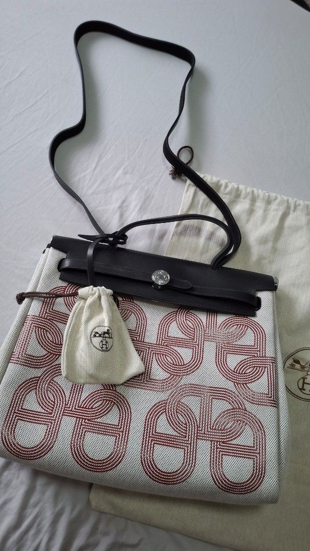 Hermes Herbag with Pouch and Dustbag (Category: Luxury Bags & Wallets) located in Angono. Submitted by bagamania (Listing ID 1445628758, Image 1). Description: - Hermes her bag - Iconic 'H' pattern - Comes with a small pouch - Includes original dust bag - Genuine leather trim and strap - Ideal for everyday use - Clean interior and exterior - Ready for a new owner.