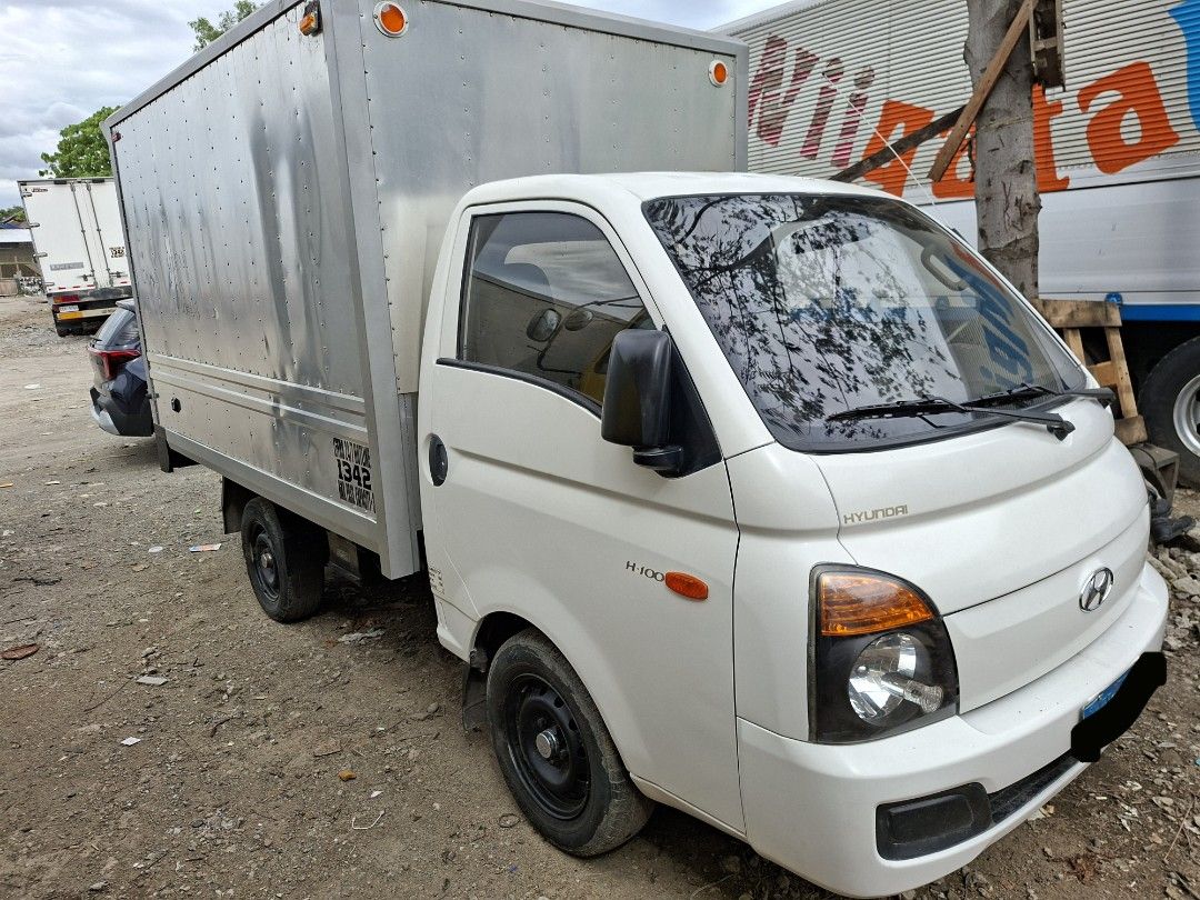 Hyundai H-100 Closed Van Manual (Category: Used Cars) located in Calamba. Submitted by fugazi.shop (Listing ID 1445791708, Image 1). Description: H-100 with NEW Aluminum Van body. In good running condition. Newly painted truck body. Newly PMS, including change oil and belt replacement. With LTO franchise (truck for hire). LTO CR changed to "CLOSED VAN" With free Kartilya. Good for business. Clean papers with original CR. Slightly negotiable..