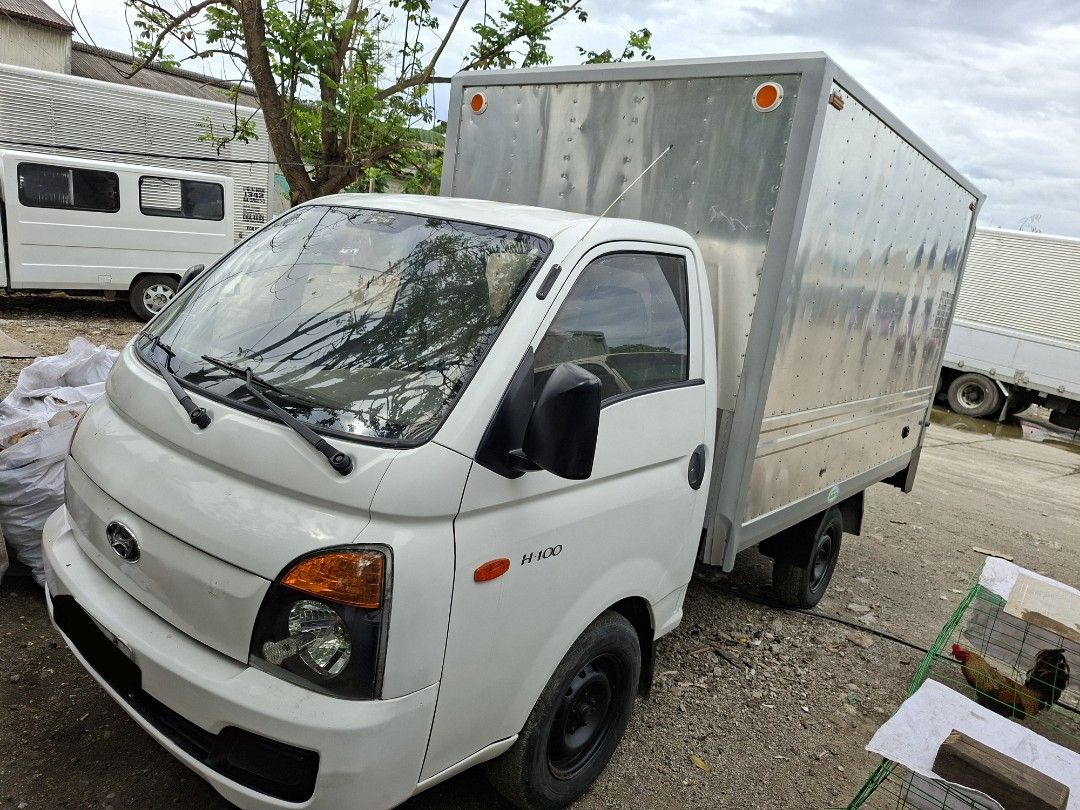 Hyundai H-100 Closed Van Manual (Category: Used Cars) located in Calamba. Submitted by fugazi.shop (Listing ID 1445791708, Image 2). Description: H-100 with NEW Aluminum Van body. In good running condition. Newly painted truck body. Newly PMS, including change oil and belt replacement. With LTO franchise (truck for hire). LTO CR changed to "CLOSED VAN" With free Kartilya. Good for business. Clean papers with original CR. Slightly negotiable..