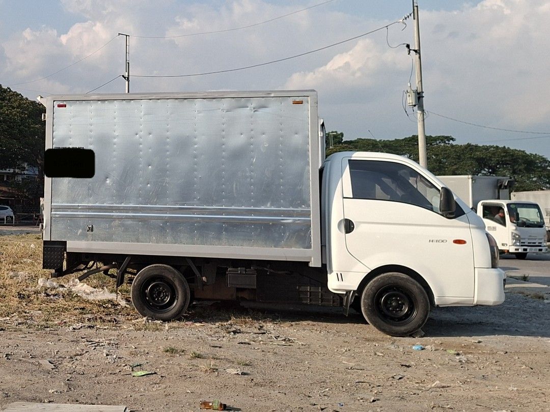 Hyundai H-100 Closed Van Manual (Category: Used Cars) located in Calamba. Submitted by fugazi.shop (Listing ID 1445791708, Image 3). Description: H-100 with NEW Aluminum Van body. In good running condition. Newly painted truck body. Newly PMS, including change oil and belt replacement. With LTO franchise (truck for hire). LTO CR changed to "CLOSED VAN" With free Kartilya. Good for business. Clean papers with original CR. Slightly negotiable..