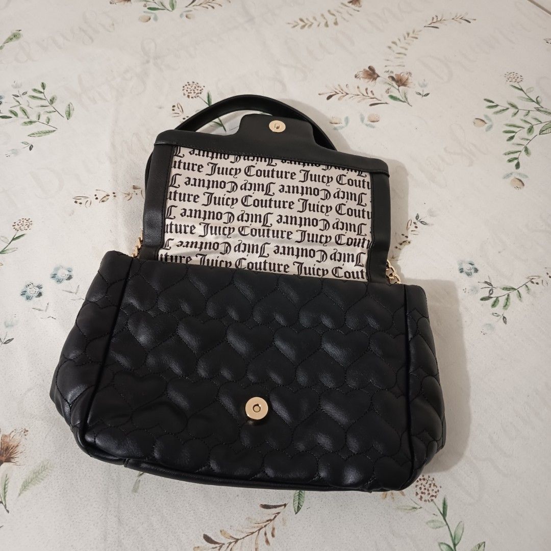 Juicy Couture Black Quilted Heart Bag (Category: Luxury Bags & Wallets) located in Pasig City. Submitted by wafflestore (Listing ID 1445609846, Image 2). Description: Authentic with papertag. Never used. It's $80 uwi from the US but it doesn't match my aesthetic 🥲 Spacious with back pocket, inner pocket, and zipped pocket. Juicy Couture lining inside. Gold JC logo with rhinestones on the front flap. Quilted heart pattern. No issues. Payment thro