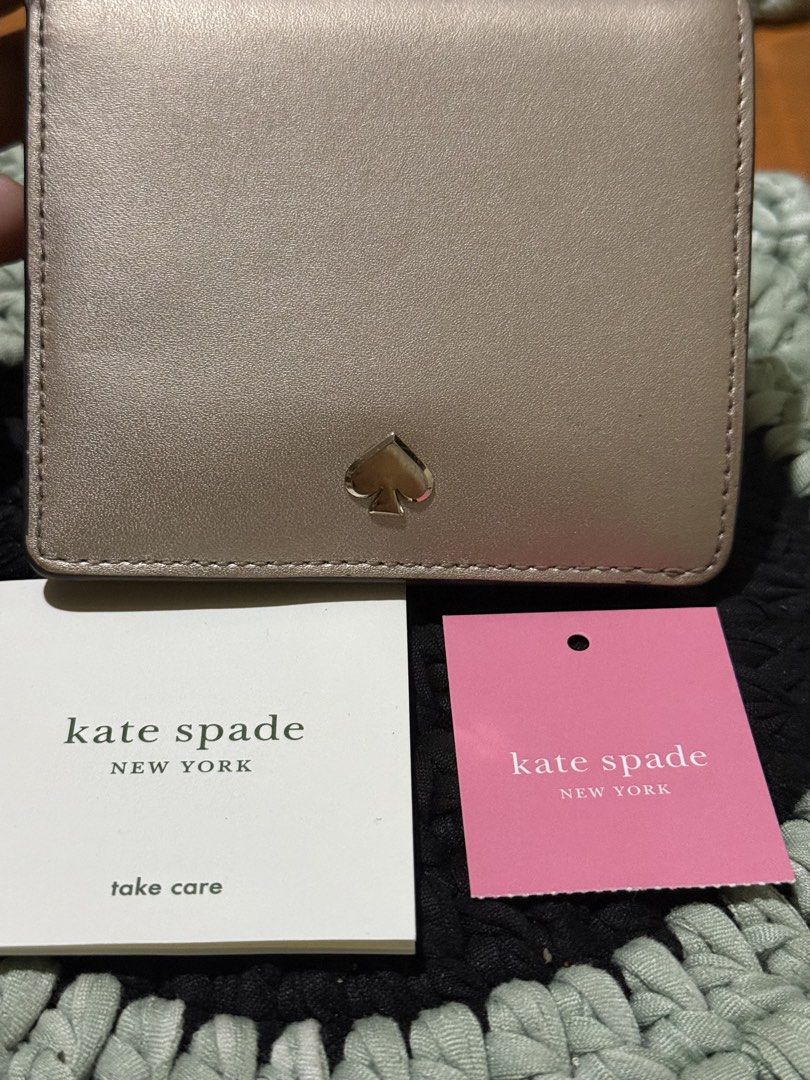 Kate Spade New York Metallic Wallet (Category: Wallets & Card holders) located in Manila. Submitted by handpickedbycox (Listing ID 1445634878, Image 2). Description: - Brand: Kate Spade - Color: Rose Gold Metallic - Condition: with original tags and care card - Features: Compact size, snap closure -Ask all you want -No COD - No return No refund - ship ng ia J&T .