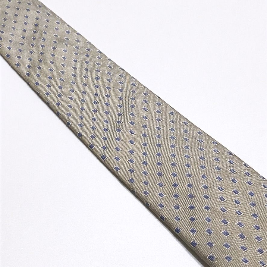 Kenneth Cole Beige Geometric Slim Neck Tie (Category: Ties) located in Taguig. Submitted by retrogaze (Listing ID 1445699159, Image 3). Description: This contemporary sleek necktie by Kenneth Cole New York delivers a sharp, modern aesthetic with an urban flair. Meticulously tailored into a versatile slim profile, the accessory is woven from 100% silk and features a sophisticated beige base. The surface is decorated with a precisely aligned, repea