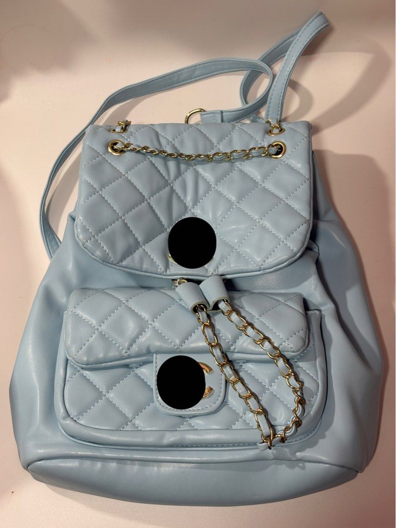 Light Blue Quilted Chain Backpack (Category: Backpacks) located in Davao. Submitted by sammyang123 (Listing ID 1445763202, Image 2). Description: - Logo hidden due to violations/DM MEFOR ACTUAL PICTURES! 10/10 no flaws pwede pan gift Buttery soft leather!🫶🏻💙 Adorable light blue quilted backpack - Chic gold chain strap details - Convenient front pocket for essentials - Spacious main compartment for your belongings - Secure drawstring closure wi