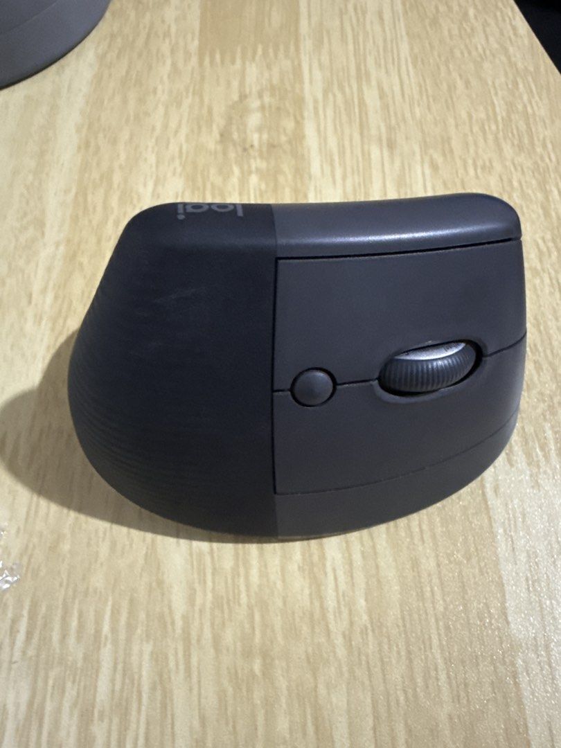 Logitech MX Lift Vertical Ergonomic Mouse (Category: Mouse & Mousepads) located in Las Pinas. Submitted by paolamang (Listing ID 1445708753, Image 2). Description: - Logitech MX Vertical Mouse - Color: Dark Grey - Ergonomic design for ultimate comfort - Includes scroll wheel and buttons - Excellent working condition - Perfect for extended computer use.
