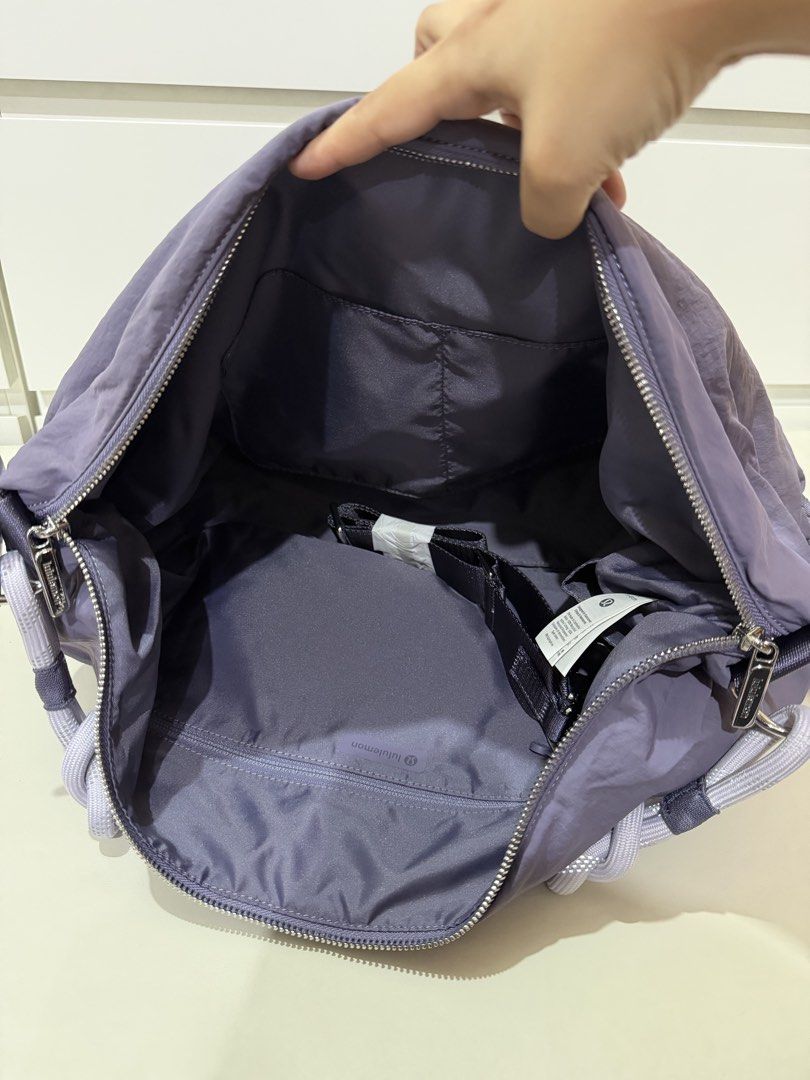 Lululemon Convertible Ruched Crossbody Bag *Large 16L - Purple (Category: Tote Bags) located in Manila. Submitted by preloved_new_forsale (Listing ID 1445768708, Image 3). Description: - Stylish purple Lululemon hobo bag - Unique gathered design with rope handles - Secure zipper closure - Interior pockets for organization - Includes an adjustable strap for versatility - Ideal for everyday wear.