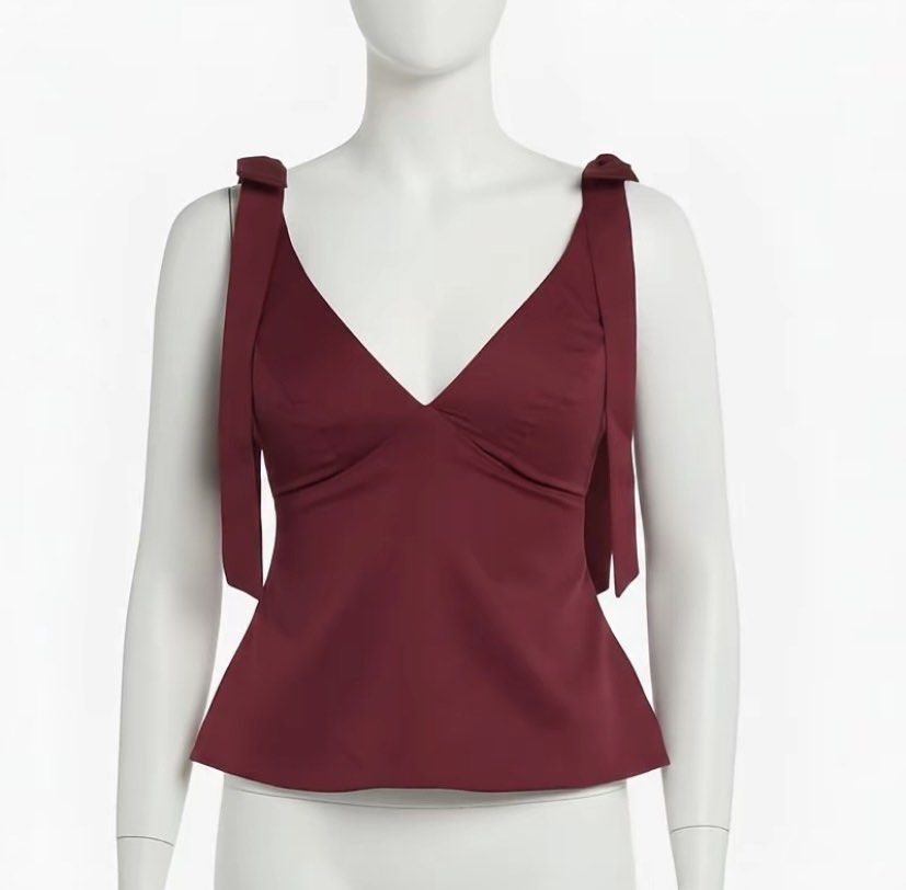 Maroon V-neck Peplum Top with Tie Shoulders (Category: Sleeveless) located in Manila. Submitted by itsmebrig (Listing ID 1445684052, Image 1). Description: - Cute maroon peplum top - V-neck design - Adjustable tie shoulder straps - Fabric with a slight sheen - Versatile: dress up or down for night out or casual day.