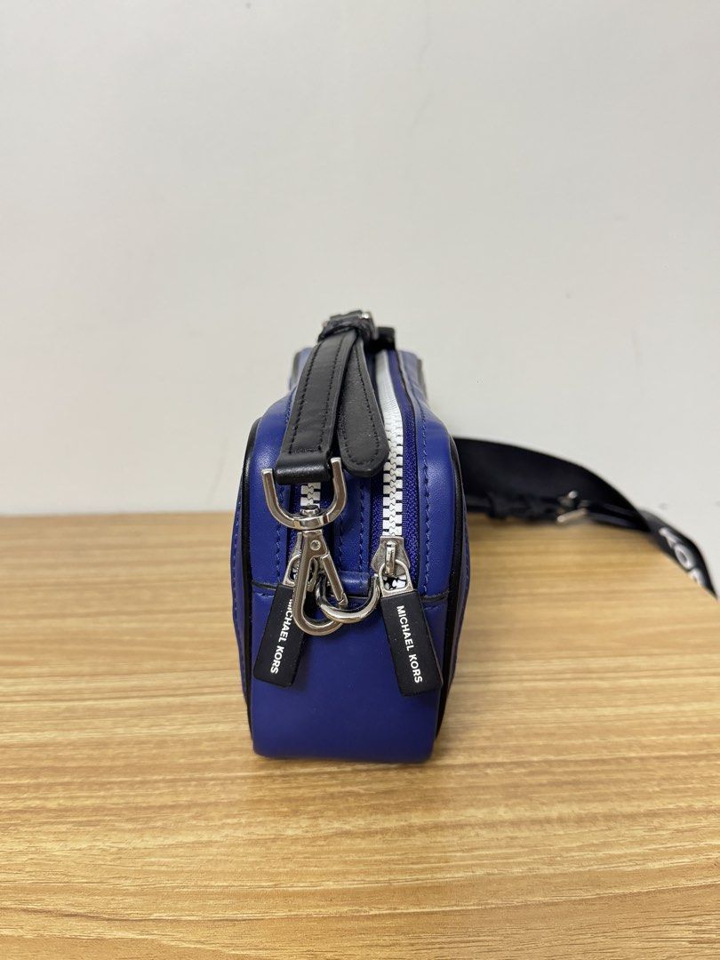 Michael Kors Blue Leather Mesh Crossbody Bag (Category: Cross-body Bags) located in Tarlac. Submitted by muchlovedstuffs (Listing ID 1445642870, Image 3). Description: - Authentic Michael Kors blue leather crossbody bag - Stylish white mesh front panel - Sleek silver hardware and zippers - Adjustable black strap with Michael Kors branding - Two spacious zip compartments - Ideal for everyday errands or travel adventures - No damage good as new.
