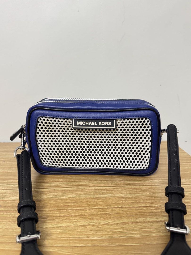 Michael Kors Blue Leather Mesh Crossbody Bag (Category: Cross-body Bags) located in Tarlac. Submitted by muchlovedstuffs (Listing ID 1445642870, Image 1). Description: - Authentic Michael Kors blue leather crossbody bag - Stylish white mesh front panel - Sleek silver hardware and zippers - Adjustable black strap with Michael Kors branding - Two spacious zip compartments - Ideal for everyday errands or travel adventures - No damage good as new.