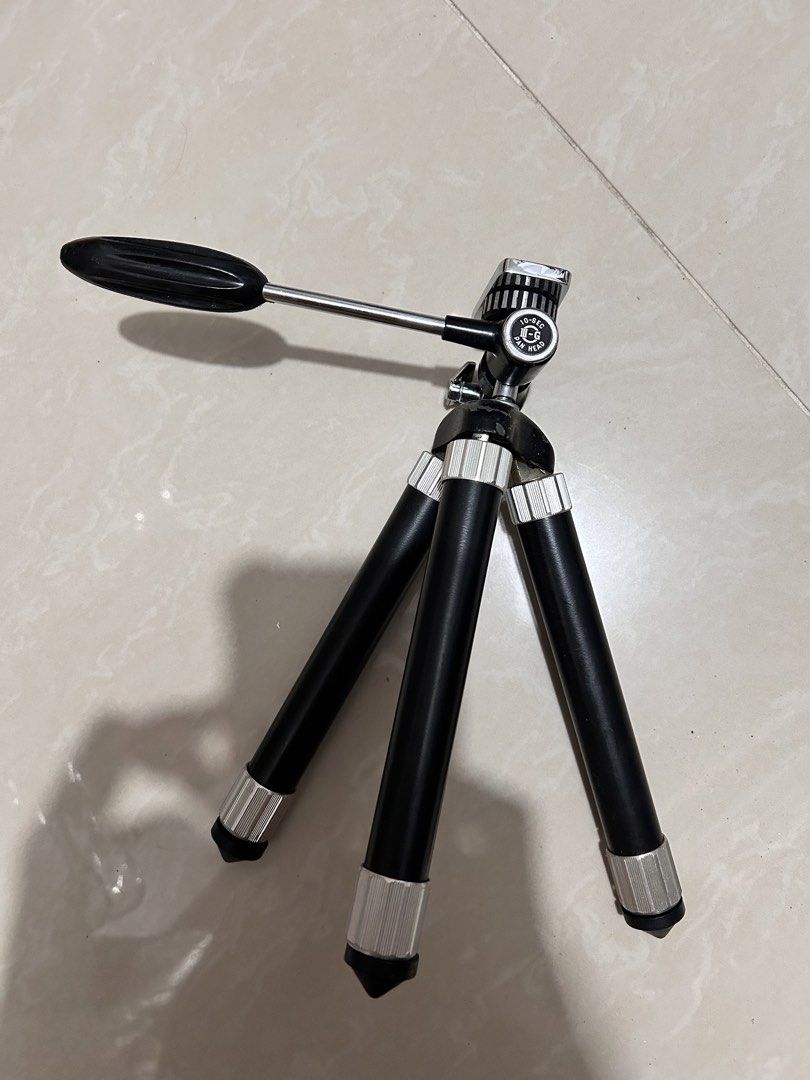 Mini Tripod with Extendable Legs (Category: Tripods & Monopods) located in Taguig. Submitted by Yanyann (Listing ID 1445748665, Image 1). Description: - Compact tripod, perfect for cameras or smartphones. - Extendable legs for adjustable height. - Features a pan head for easy camera positioning. - Small and portable, ideal for travel and everyday use. - Shows minor scuffs from normal use..