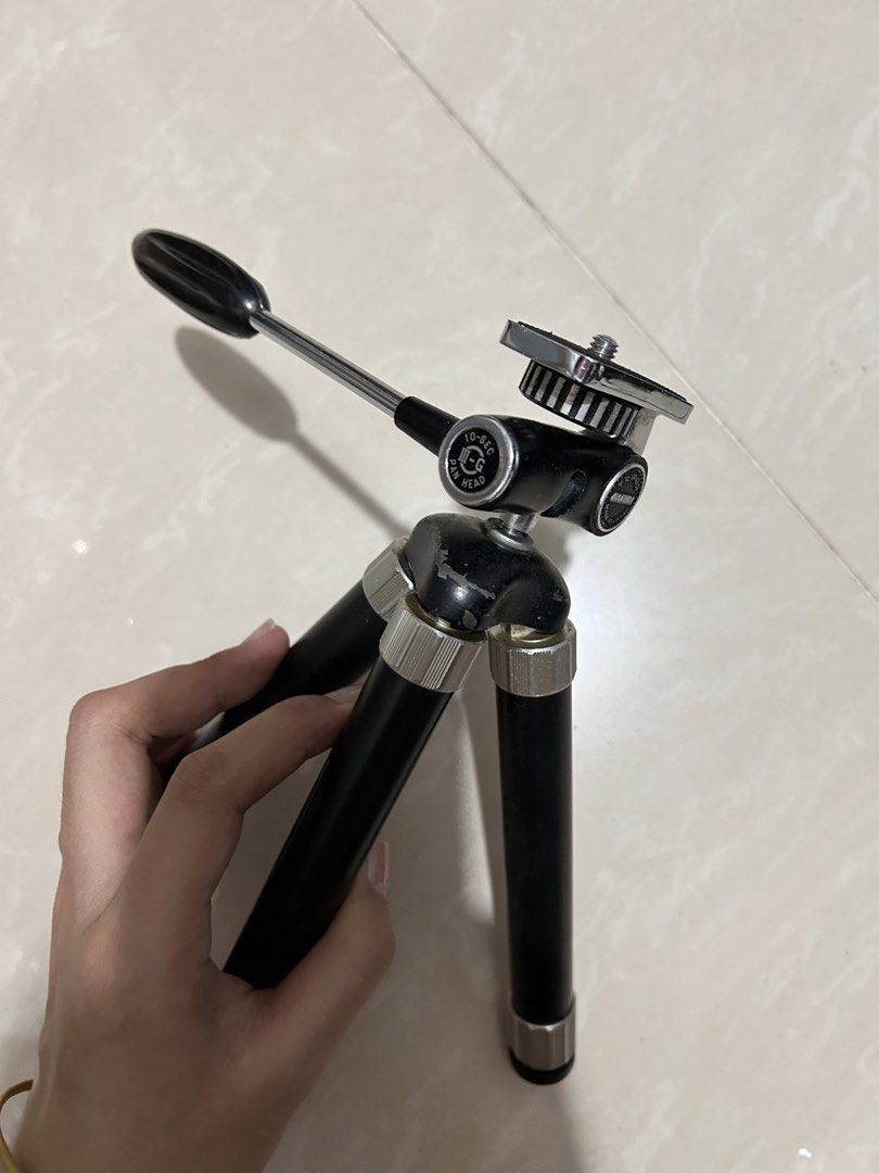 Mini Tripod with Extendable Legs (Category: Tripods & Monopods) located in Taguig. Submitted by Yanyann (Listing ID 1445748665, Image 2). Description: - Compact tripod, perfect for cameras or smartphones. - Extendable legs for adjustable height. - Features a pan head for easy camera positioning. - Small and portable, ideal for travel and everyday use. - Shows minor scuffs from normal use..