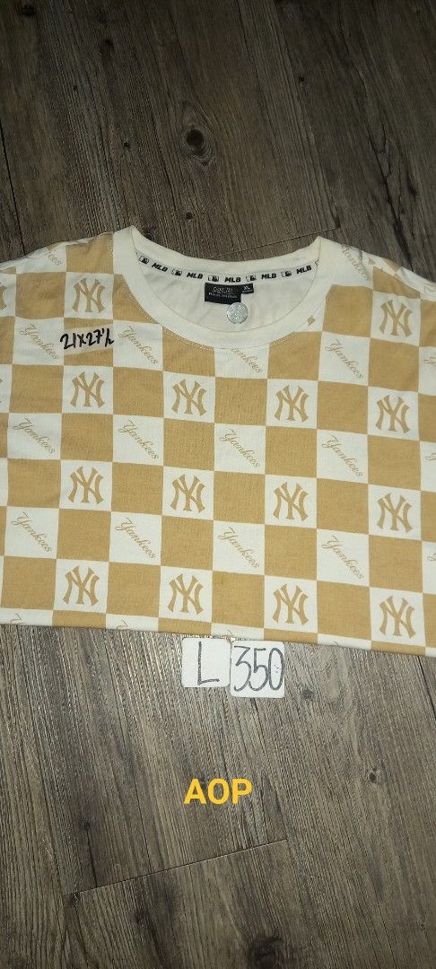 MLB New York Yankees Checkerboard All Over Print (Category: Tshirts & Polo Shirts ) located in Imus. Submitted by pampie (Listing ID 1445784372, Image 1). Description: - Cream and tan checkerboard pattern - All-over New York Yankees logo print - MLB branded - Size: L - Comfortable and stylish design - Perfect for any Yankees fan.