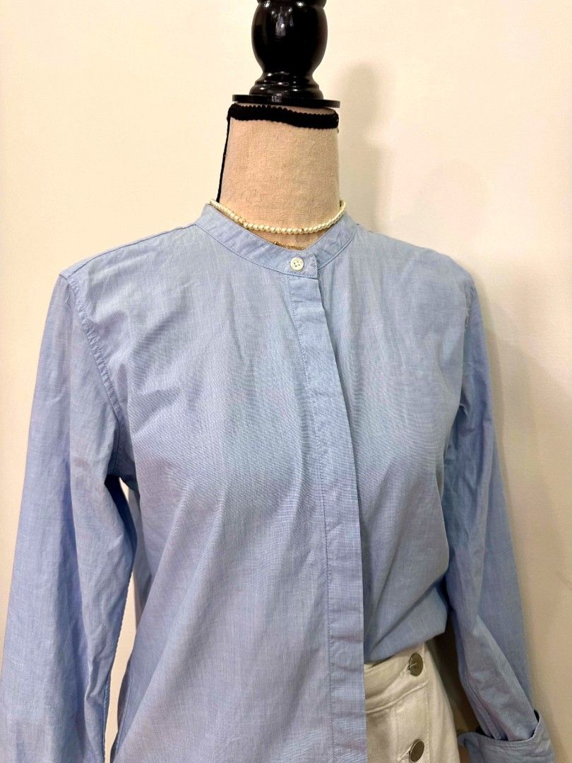 MUJI (M) Light Blue Long Sleeve Button Up Shirt (Category: Longsleeves) located in Davao. Submitted by closetaccess (Listing ID 1445657563, Image 3). Description: - Light blue long sleeve shirt - Mandarin collar - Regular to slim fit fit - 100% cotton fabric - Size Medium (M) - Button-up front closure - Single button at collar - Button cuffs on sleeves.