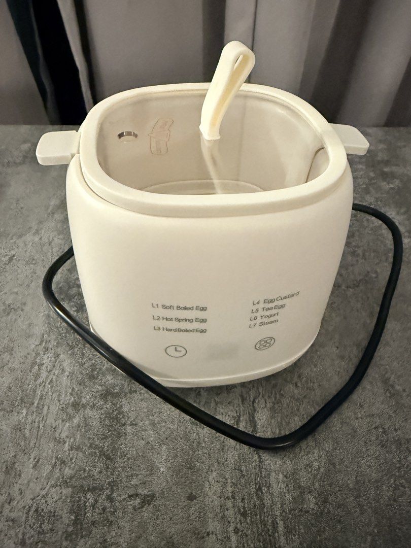 Multi-Function Egg Cooker (Category: Cookers) located in Singapore. Submitted by zahuobarangbarang (Listing ID 1445768163, Image 1). Description: - White multi-function cooker - Perfect for various egg preparations: soft boiled, hot spring, hard boiled, egg custard, tea eggs, yogurt - Includes a steam function - Easy operation with preset settings.
