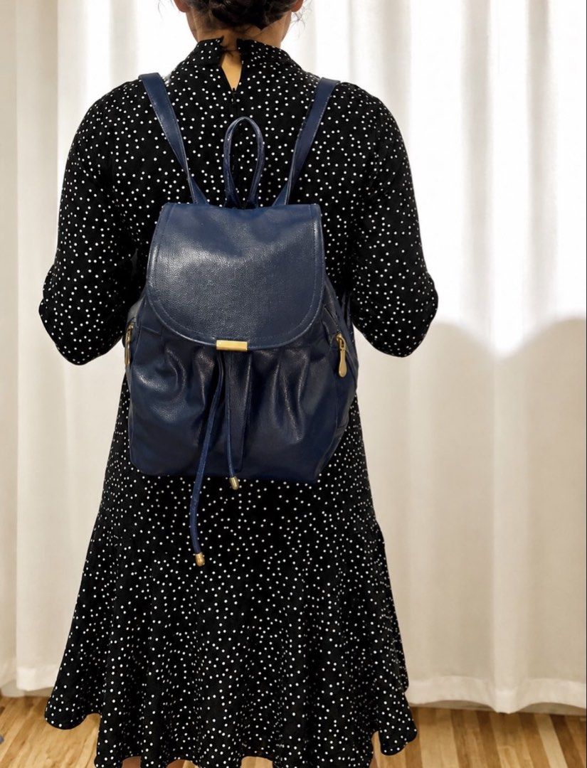 Navy Blue Leather Drawstring Backpack (Category: Backpacks) located in Quezon City. Submitted by rebagged.mnl (Listing ID 1445685737, Image 2). Description: +Php100 sf within MM via J&T - Cute navy blue backpack - Drawstring closure with flap top and gold buckle - Adjustable shoulder straps - Ideal for everyday use.