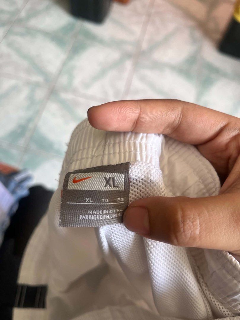 Nike White Track Pants with Zips (Category: Joggers) located in Tabuk. Submitted by iinnkk (Listing ID 1445632932, Image 2). Description: - Flaws seen last pic - White Nike track pants - Black accents on sides - Ankle zips for easy on/off - Comfortable elastic waistband - Size XL - Ideal for workouts or casual wear.
