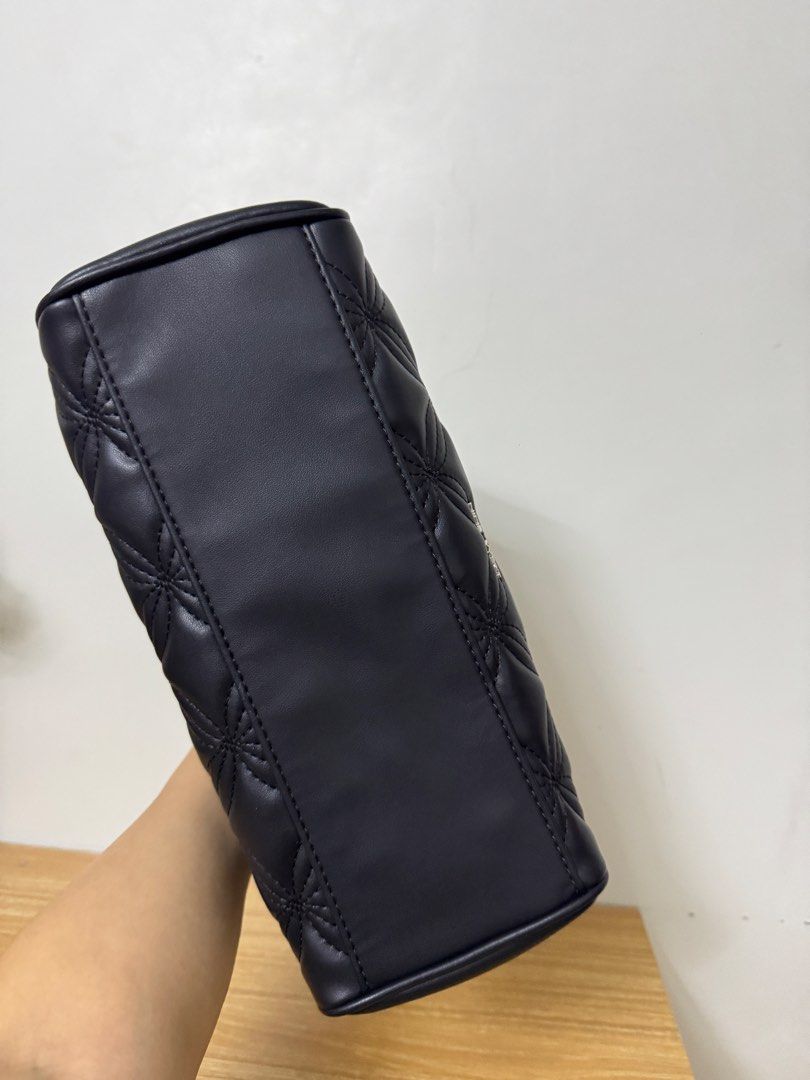 Nine West Quilted Satchel Handbag Black (Category: Luxury Bags & Wallets) located in Tarlac. Submitted by muchlovedstuffs (Listing ID 1445643835, Image 3). Description: - Brand: Nine West - Color: Black - Design: All-over quilted pattern - Handles: Top handles - Strap: Detachable shoulder strap included - Closure: Magnetic snap closure - Interior: 1 zip pocket, 1 slip pocket - Condition: Brand new, never used - Extras: Original tags attached.