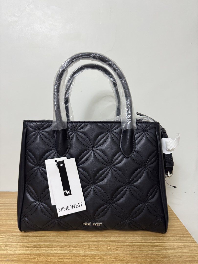 Nine West Quilted Satchel Handbag Black (Category: Luxury Bags & Wallets) located in Tarlac. Submitted by muchlovedstuffs (Listing ID 1445643835, Image 1). Description: - Brand: Nine West - Color: Black - Design: All-over quilted pattern - Handles: Top handles - Strap: Detachable shoulder strap included - Closure: Magnetic snap closure - Interior: 1 zip pocket, 1 slip pocket - Condition: Brand new, never used - Extras: Original tags attached.