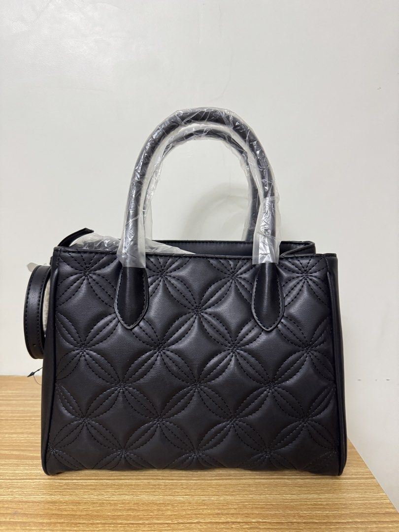 Nine West Quilted Satchel Handbag Black (Category: Luxury Bags & Wallets) located in Tarlac. Submitted by muchlovedstuffs (Listing ID 1445643835, Image 2). Description: - Brand: Nine West - Color: Black - Design: All-over quilted pattern - Handles: Top handles - Strap: Detachable shoulder strap included - Closure: Magnetic snap closure - Interior: 1 zip pocket, 1 slip pocket - Condition: Brand new, never used - Extras: Original tags attached.