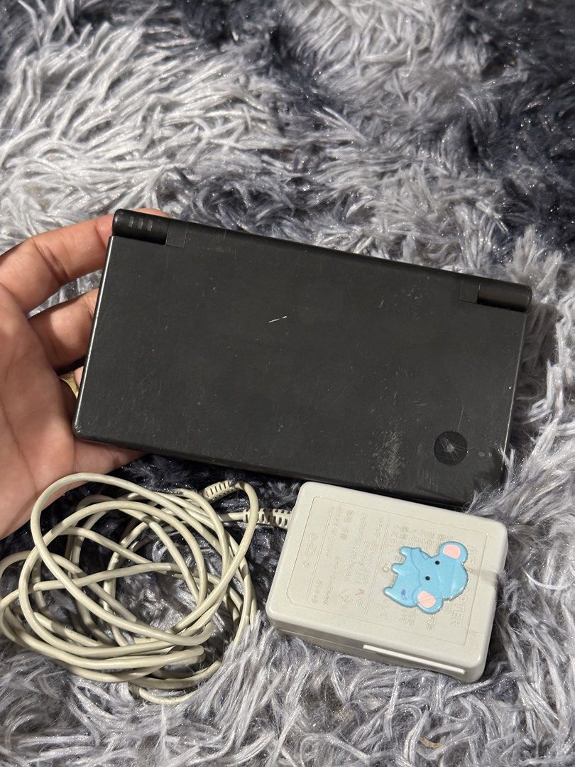Nintendo DS Lite (Black) with Charger (Category: Nintendo) located in Taytay. Submitted by CharmingSelections (Listing ID 1445777129, Image 3). Description: - Black Nintendo DS Lite console -Japanese - Includes original charger - Powers on and displays the Nintendo DS logo - Bottom screen shows a safety warning in Japanese - Minor scratches visible on the bottom screen - Ideal for gaming on the go.