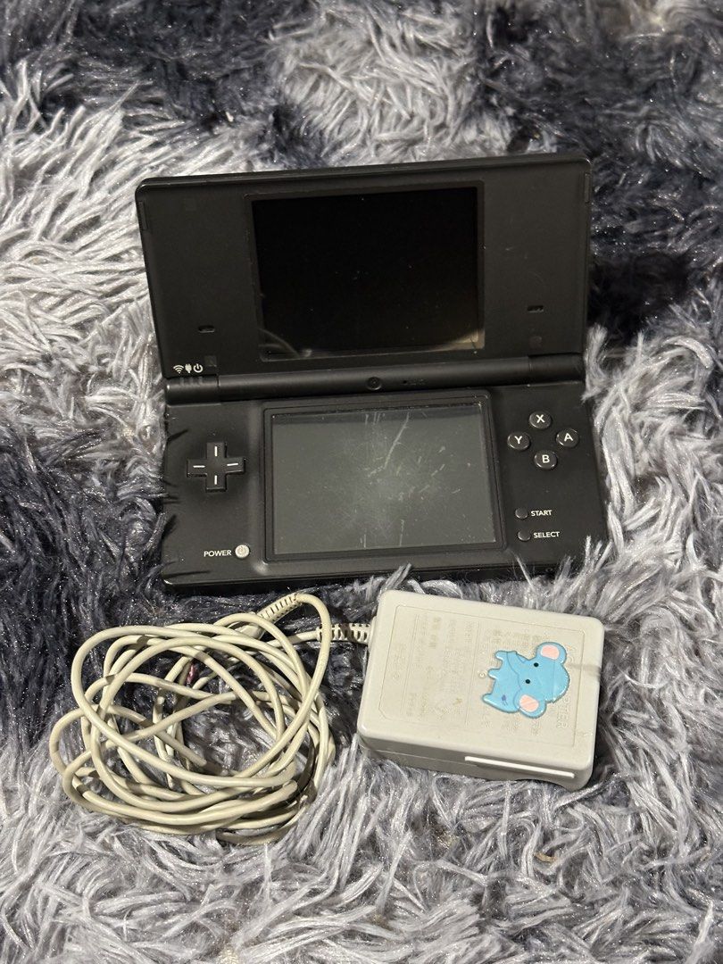Nintendo DS Lite (Black) with Charger (Category: Nintendo) located in Taytay. Submitted by CharmingSelections (Listing ID 1445777129, Image 1). Description: - Black Nintendo DS Lite console -Japanese - Includes original charger - Powers on and displays the Nintendo DS logo - Bottom screen shows a safety warning in Japanese - Minor scratches visible on the bottom screen - Ideal for gaming on the go.