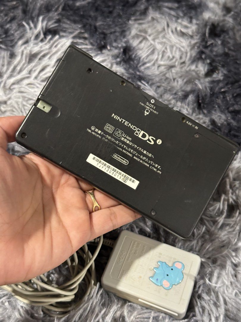Nintendo DS Lite (Black) with Charger (Category: Nintendo) located in Taytay. Submitted by CharmingSelections (Listing ID 1445777129, Image 2). Description: - Black Nintendo DS Lite console -Japanese - Includes original charger - Powers on and displays the Nintendo DS logo - Bottom screen shows a safety warning in Japanese - Minor scratches visible on the bottom screen - Ideal for gaming on the go.