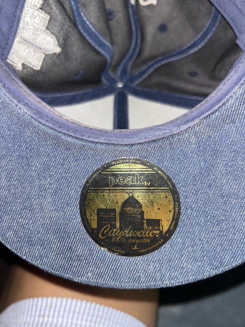 Peak Television Denim Dog Ear Cap (Category: Caps & Hats) located in Manila. Submitted by bella_69 (Listing ID 1445742729, Image 2). Description: - Stylish denim cap with cozy fur ear flaps. - Unique 'Peak TV' embroidery on front and back. - 'Citydweller' embroidery on the side. - Crafted from 100% polyester for durability. - Perfect for making a statement with your look. .